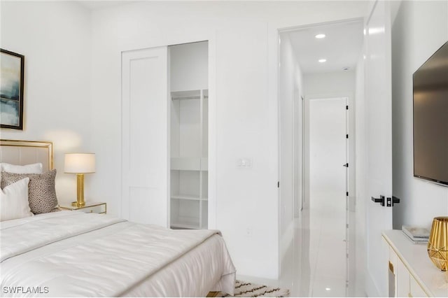 bedroom with recessed lighting and a closet