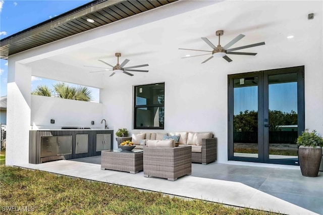 view of patio / terrace with an outdoor kitchen, french doors, outdoor lounge area, and ceiling fan