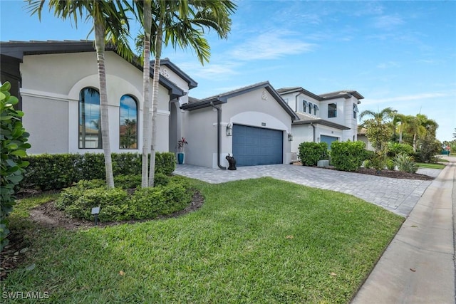 10111 Palazzo Dr, Naples, FL 34119 - mediterranean / spanish home featuring stucco siding, a front yard, decorative driveway, and an attached garage