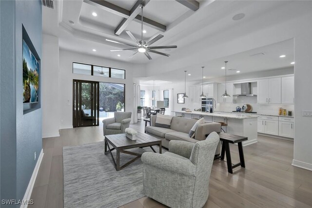 10111 Palazzo Dr, Naples, FL 34119 - living room featuring coffered ceiling, recessed lighting, ceiling fan, beam ceiling, and light wood-style flooring
