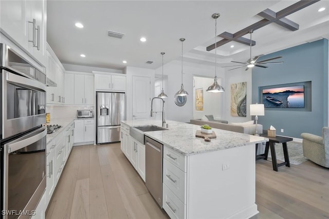 10111 Palazzo Dr, Naples, FL 34119 - kitchen featuring appliances with stainless steel finishes, a sink, coffered ceiling, light wood-style flooring, and recessed lighting