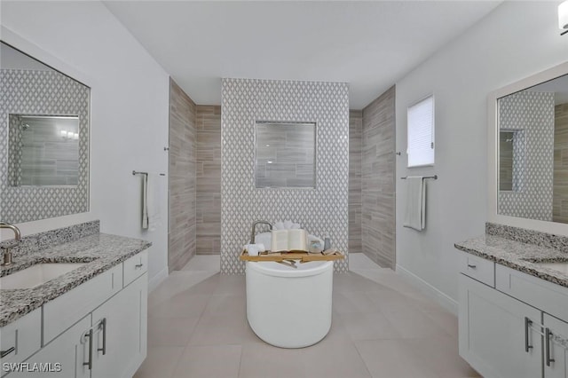 10111 Palazzo Dr, Naples, FL 34119 - bathroom featuring two vanities, a walk in shower, a freestanding tub, and tile patterned floors