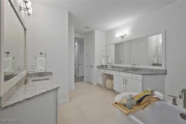 10111 Palazzo Dr, Naples, FL 34119 - bathroom with two vanities and baseboards