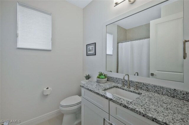 10111 Palazzo Dr, Naples, FL 34119 - full bath featuring vanity, toilet, baseboards, and curtained shower