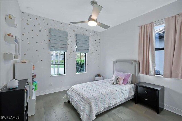10111 Palazzo Dr, Naples, FL 34119 - bedroom with baseboards, ceiling fan, wallpapered walls, and wood finished floors
