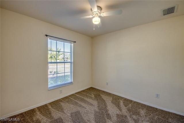 empty room featuring visible vents, carpet floors, baseboards, and ceiling fan