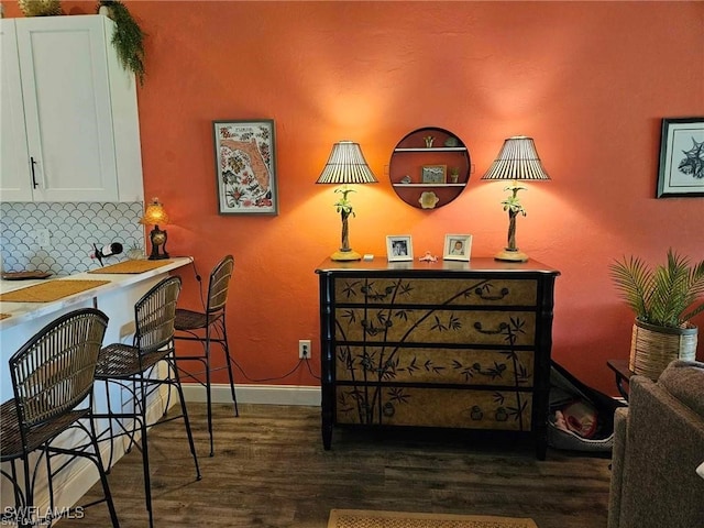 interior space featuring baseboards and wood finished floors