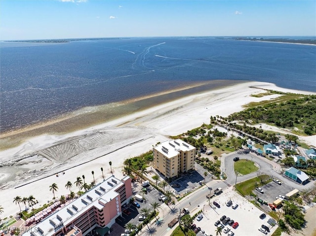 bird's eye view with a water view and a beach view