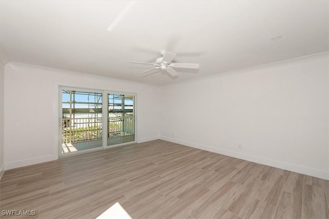 empty room featuring baseboards, light wood-style flooring, and a ceiling fan