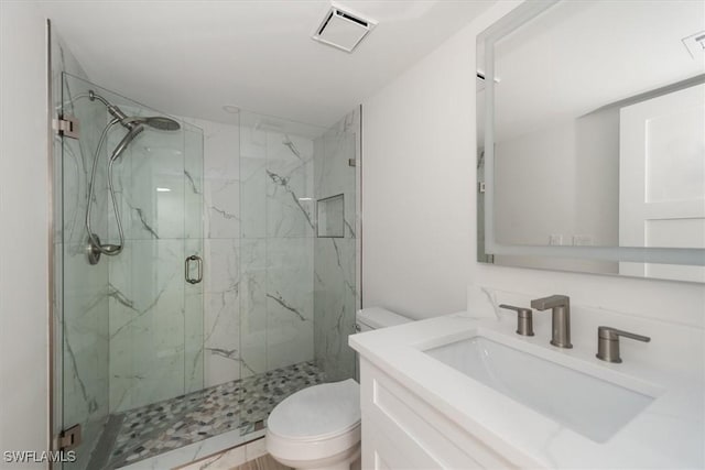 full bathroom featuring a marble finish shower, visible vents, toilet, and vanity