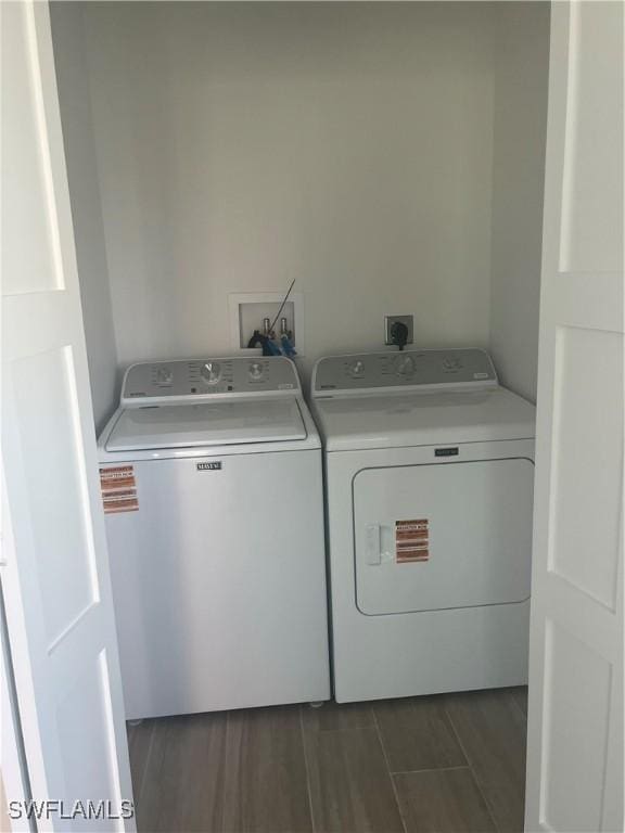 100 Estero Blvd Unit 131, Fort Myers Beach, FL 33931 - laundry area featuring washing machine and clothes dryer and dark wood finished floors