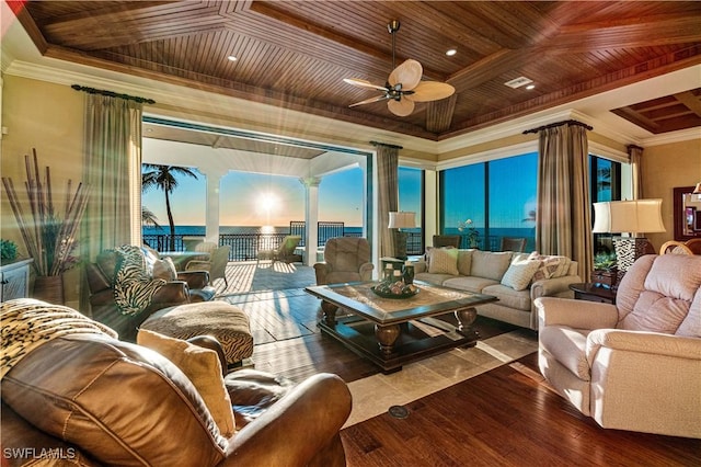 living room featuring wood finished floors, wood ceiling, a tray ceiling, and ornamental molding