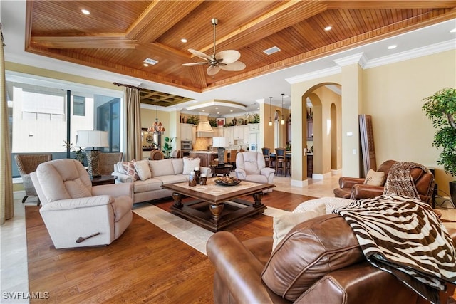 living area with light wood finished floors, arched walkways, wood ceiling, and ornamental molding