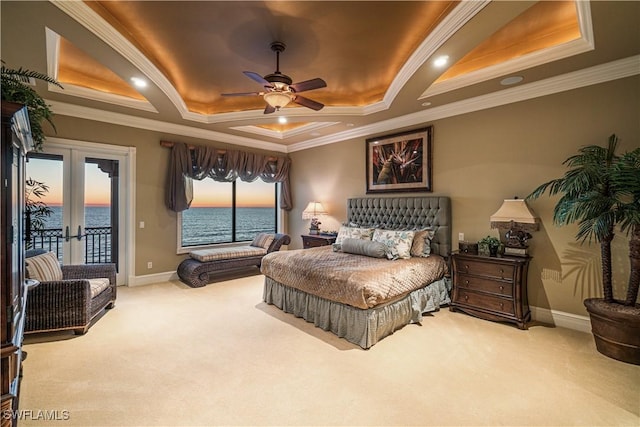 carpeted bedroom featuring crown molding, baseboards, french doors, a raised ceiling, and access to outside