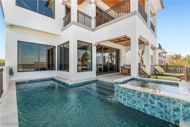 view of swimming pool with a patio area and a pool with connected hot tub