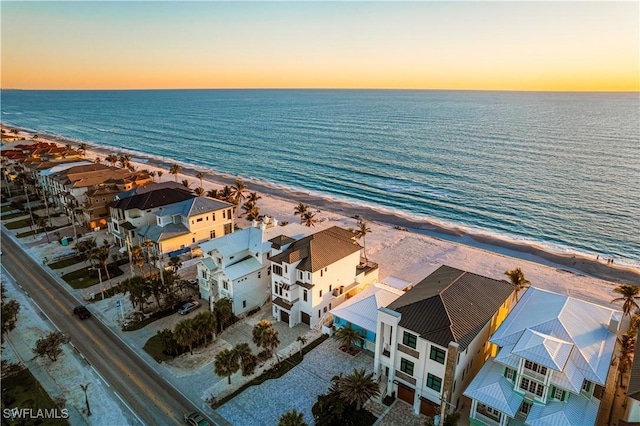 aerial view featuring a residential view, a water view, and a beach view