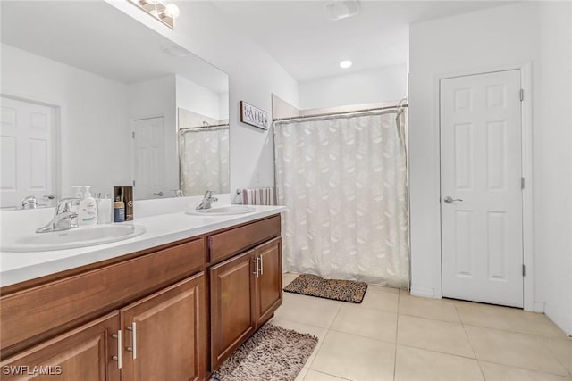 full bathroom with a shower with shower curtain, tile patterned floors, double vanity, and a sink