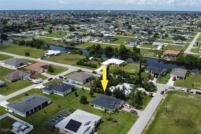 drone / aerial view with a residential view and a water view