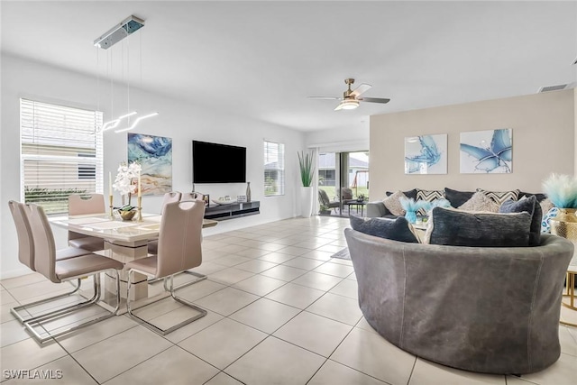 living area with ceiling fan, visible vents, and light tile patterned flooring