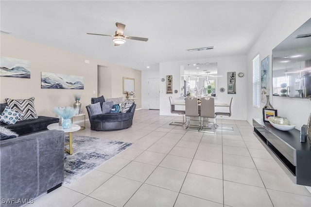 living area with light tile patterned floors and ceiling fan