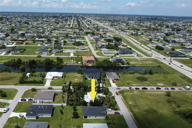 birds eye view of property featuring a residential view and a water view