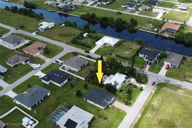 drone / aerial view featuring a residential view and a water view