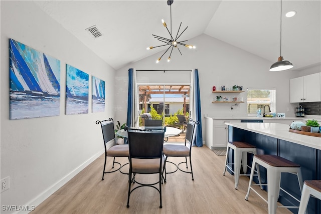 dining area featuring vaulted ceiling, a notable chandelier, light wood-style floors, and visible vents