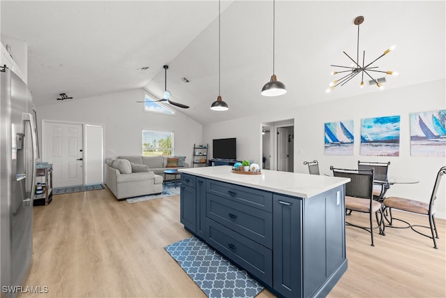 kitchen with a kitchen island, lofted ceiling, stainless steel refrigerator with ice dispenser, decorative light fixtures, and light wood-type flooring