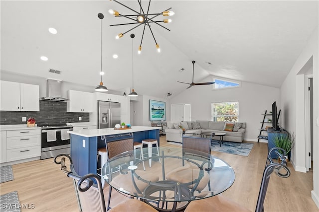 dining area with visible vents, baseboards, light wood-style floors, and high vaulted ceiling