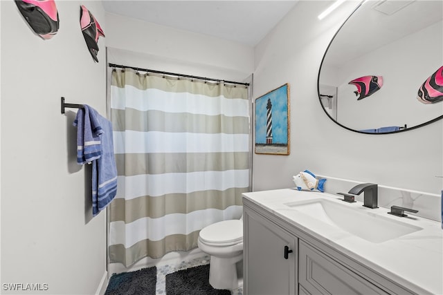 bathroom featuring a shower with curtain, toilet, and vanity