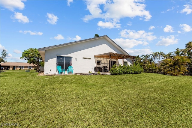 rear view of property featuring stucco siding, a patio, a pergola, and a lawn