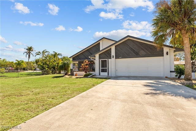 mid-century home with a front lawn, fence, a garage, and driveway