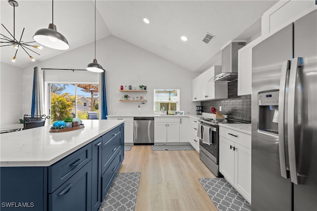 kitchen featuring open shelves, light wood-style floors, appliances with stainless steel finishes, white cabinetry, and wall chimney range hood