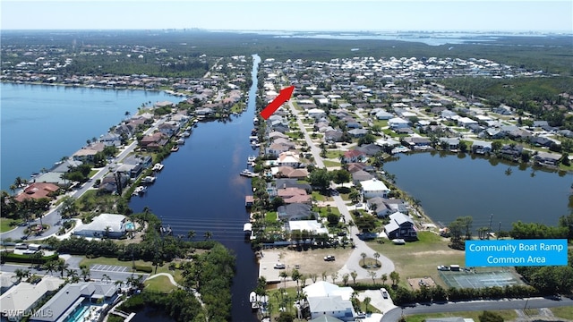 drone / aerial view with a residential view and a water view