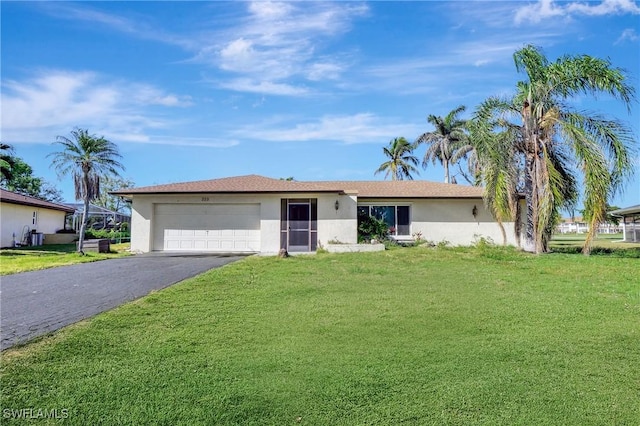 ranch-style home featuring a garage, a front lawn, driveway, and stucco siding