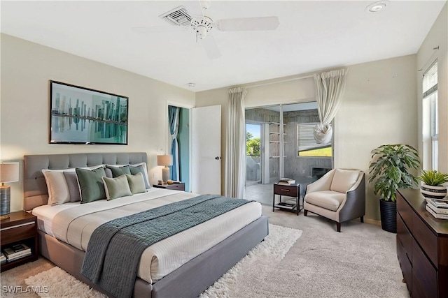 bedroom featuring access to exterior, visible vents, light carpet, and a ceiling fan