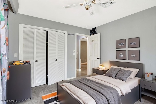 carpeted bedroom with visible vents, baseboards, and a closet