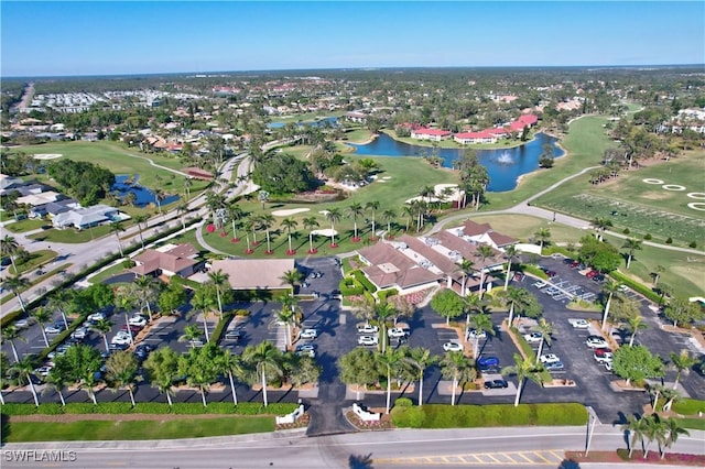 drone / aerial view with golf course view, a water view, and a residential view