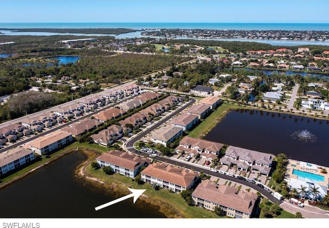 bird's eye view with a residential view and a water view