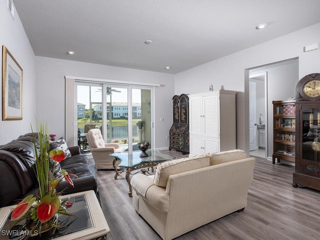 living room featuring visible vents, recessed lighting, and wood finished floors