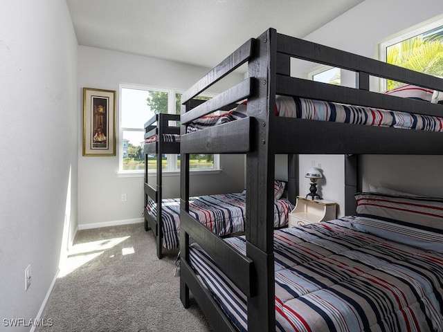 bedroom with baseboards and carpet flooring