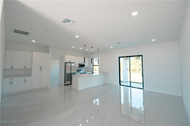 kitchen featuring visible vents, white cabinets, stainless steel appliances, and open floor plan