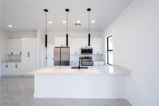 kitchen with visible vents, light countertops, marble finish floor, stainless steel appliances, and a sink