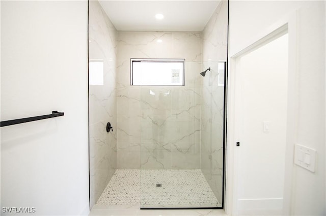 full bath with a marble finish shower and recessed lighting