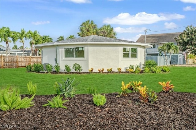 back of house with fence and a yard