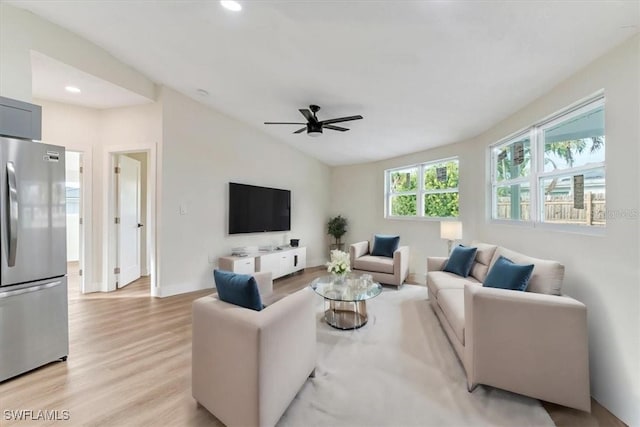 living room featuring ceiling fan, recessed lighting, vaulted ceiling, and light wood-style flooring