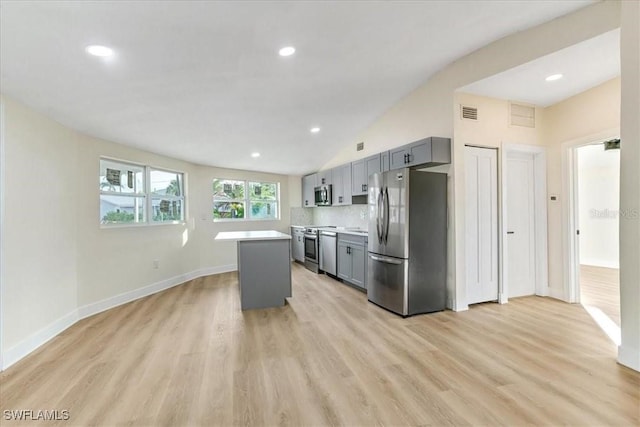 kitchen with light wood-type flooring, light countertops, appliances with stainless steel finishes, and gray cabinets