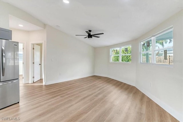 empty room with light wood finished floors, lofted ceiling, recessed lighting, and ceiling fan