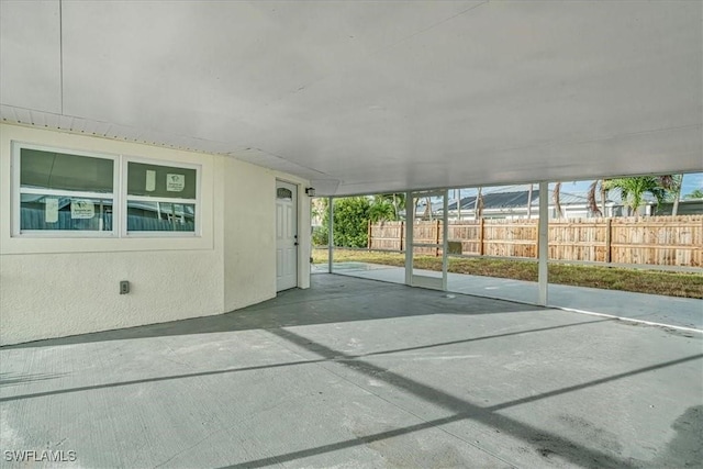 view of patio with fence and a carport
