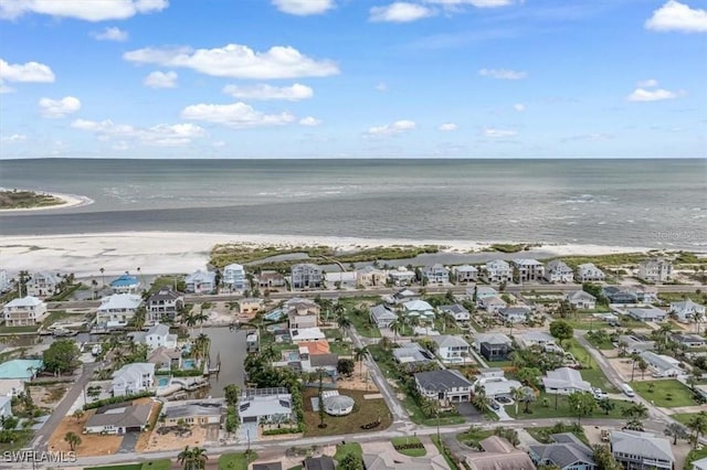 aerial view featuring a beach view, a water view, and a residential view
